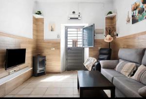 a living room with a couch and a television at Casa Adela in Barbate