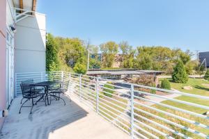 a balcony with a table and chairs on it at The Crash Pad: An Uncommon Hostel in Chattanooga +7 photos