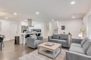 a living room with two couches and a table at Spacious Decatur Home Sleeps 12, Work-Ready in Decatur