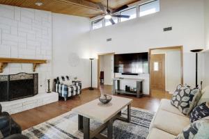 a living room with a couch and a table at Highland Village - 4BR w Backyard Pool Oasis in Highland Village