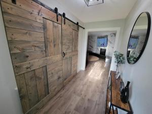 a sliding barn door in a hallway with a mirror at Ridgefield Estate 5BED Backyard Games in Plano
