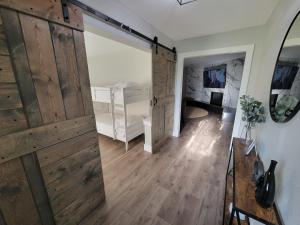 a room with a sliding barn door and a bedroom at Ridgefield Estate 5BED Backyard Games in Plano