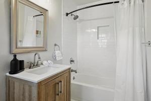 a bathroom with a sink and a shower with a mirror at 3-BD 2-BA Tranquil Rural Retreat - Perfect for 6 in Sherman +27 photos