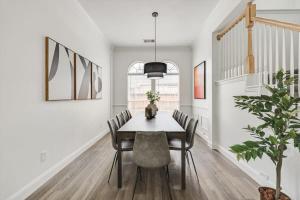 a dining room with a table and chairs at Stunning 6BR Pool - Great for Big Groups in Rowlett