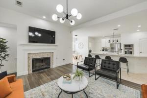 a living room with a fireplace and a tv at Stunning 6BR Pool - Great for Big Groups in Rowlett +44 photos