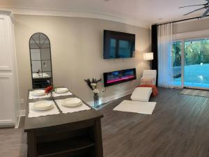 a living room with a table with plates on it at Charming Gainesville Townhome 3 in Gainesville