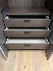 three drawers in a closet with a wooden floor at Appartamento Piero in Calenzano