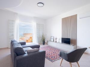 a living room with a couch and a tv at Villa Moon Total Relax in Alcamo