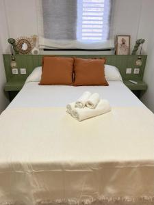 a bedroom with a bed with two towels on it at Casa La Cañada in San Sebastián de la Gomera +5 photos