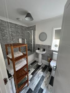 a bathroom with a shower and a sink at Elro House Holiday Let in Tillicoultry