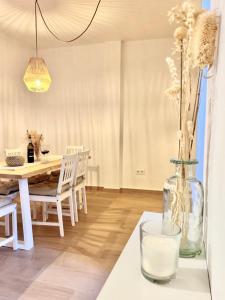 a dining room with a table and a vase with flowers at Casa La Cañada in San Sebastián de la Gomera