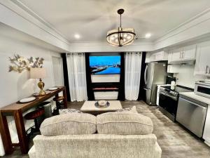 a living room with a couch and a kitchen at Glamorous Hideaway in Gainesville