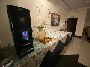 a room with a table with a video game machine at Maxim Plaza Hotel in Juiz de Fora