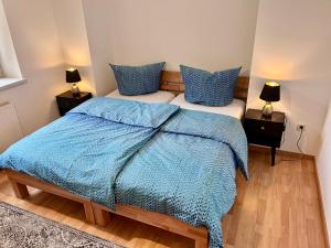 a bedroom with two beds with blue and white sheets at Apartment in Grimma mit 2 Schlafzimmer in Grimma