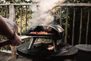 a person is cooking food on a grill at Walden in Bromyard