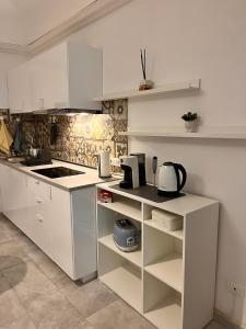 a kitchen with white counters and white cabinets at Trend22 Guest House in Pisa +30 photos