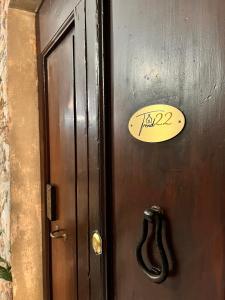 a wooden door with a sign on it at Trend22 Guest House in Pisa