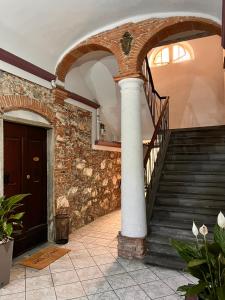 a building with a spiral staircase and a column at Trend22 Guest House in Pisa