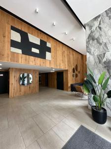 a lobby of a building with a sign on the wall at Departamento Estudio in Concepción