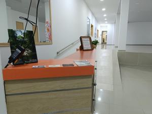 una hall con bancone arancione in un edificio di Hotel Empresarial a Pereira