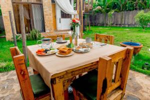 a table with plates of food on top of it at Tiny house with amazing view in Arusha