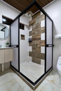 un bagno con doccia con porta in vetro di APARTAMENTO LA CAPITAL a San José