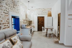 a kitchen and living room with a couch and a table at La Casita in Almuñécar