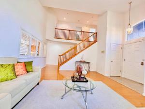 a living room with a white couch and a glass table at Furnished 4BD-3BA Union City Home Central Location in Union City