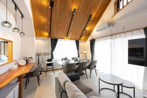 a dining room and living room with a table and chairs at Hotel Iemirai Nakano Penthouse - SHINJUKU 12min train ride in Tokyo
