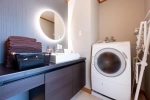 a bathroom with a washing machine and a sink at Hotel Iemirai Nakano Penthouse - SHINJUKU 12min train ride in Tokyo
