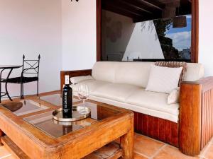 a living room with a white couch and a table at Casa Buna Colorada in Playa Blanca