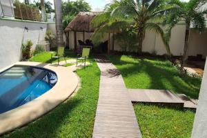 een tuin met een houten loopbrug naast een zwembad bij House completely furnished Total privacy 8Pax in Cancun