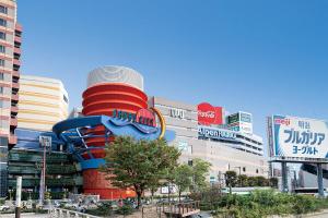a building with a water slide in a city at HOTEL FORZA HAKATAEKI CHIKUSHI-GUCHI Ⅰ in Fukuoka