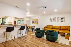 a living room with a couch and some chairs at Serene Oasis Sauna and Cinema in Paso Robles