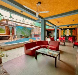 a living room with a red couch and a table at Soleil Suites in Iquitos