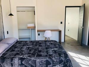a bedroom with a bed and a desk at Industrialhaus Alberca privada y climatizada in Ahuatepec +67 photos