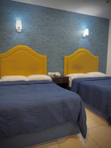 Postel nebo postele na pokoji v ubytování Hotel Maioris Kumate Culiacán