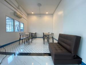Ban Nong Waengสิริธิราเพลส Sirithira Place的带沙发和桌椅的客厅