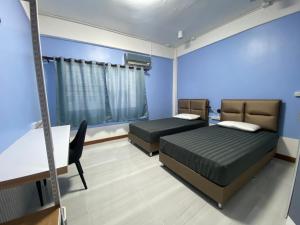 สิริธิราเพลส Sirithira Place客房内的一张或多张床位