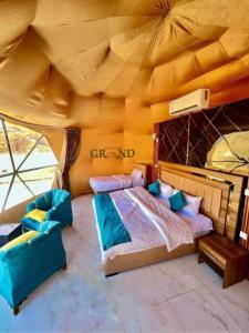 a bedroom with a bed in a tent at WADI RuM GRAND in Wadi Rum