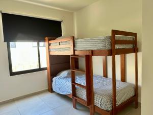 two bunk beds in a room with a window at Private Room Bunk Bed Queretaro Entrance in Miranda +49 photos