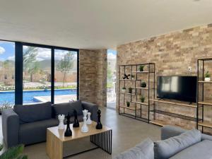 a living room with a couch and a tv at Private Room Bunk Bed Queretaro Entrance in Miranda