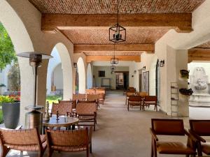 an empty restaurant with tables and chairs and a ceiling at Private Room Bunk Bed Queretaro Entrance in Miranda
