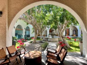 an archway with benches and a fountain in a courtyard at Private Room Bunk Bed Queretaro Entrance in Miranda