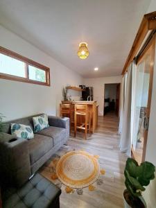 a living room with a couch and a kitchen at Colibrí Villa, 800 m from Beach in Uvita +13 photos