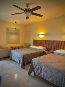a hotel room with two beds and a ceiling fan at Hotel Maioris Kumate Culiacán in Culiacán +31 photos