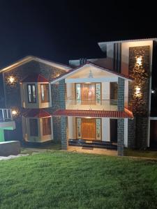 a house with a green lawn in front of it at Ecstatic Stay - Beautiful 2BHK Cottage, Resort, Villa, HomeStay in Kodaikanal in Kodaikānāl +21 photos