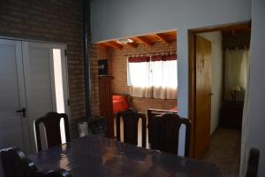 a dining room with a table and some chairs at Cabañas MACONDO in Villa Ciudad Parque +10 photos