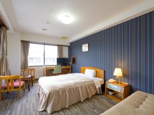 Postel nebo postele na pokoji v ubytování Hisai Green Hotel + 37 fotografií