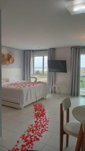 1 dormitorio con 1 cama con corazones rojos en el suelo en Flat Mandai Praia do Forte, en Cabo Frío 58 fotos más